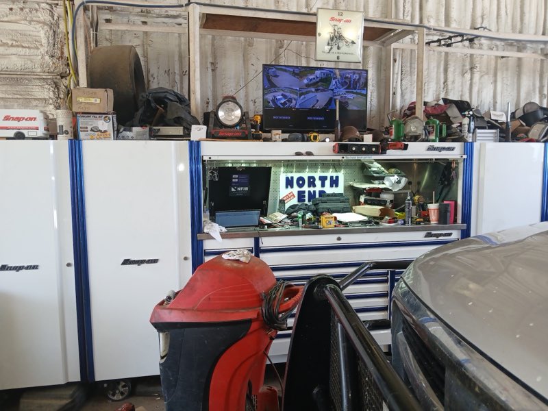 Inside the shop with Snap-on tool cabinets and a lit North End sign